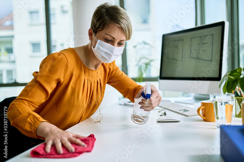 Fotografía Disinfecting her workspace!