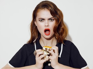 young woman eating a cake