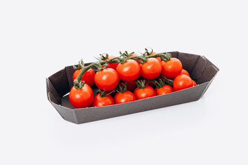 Wall Mural - Red tomatoes in a plastic pack. Isolated, white background. White background with reflection.