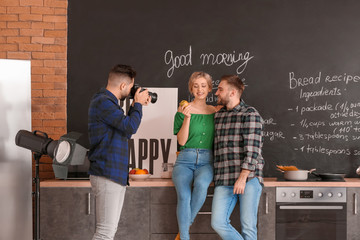 Wall Mural - Photographer working with young couple in studio