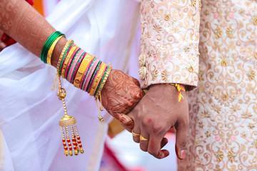 Wall Mural - Traditional indian wedding ceremony, groom holding bride hand