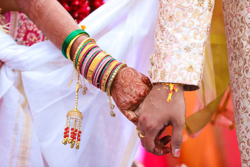 Wall Mural - Traditional indian wedding ceremony, groom holding bride hand