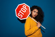 Displeased african woman holding stop symbol sign.