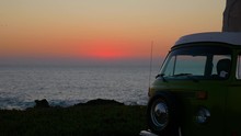 Spectacular Sunset Over The Atlantic Ocean With A Retro Camper Van In Cabo De Roca. Green Combi T1 Westfalia .