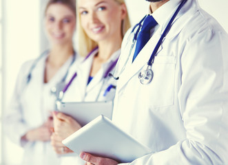 Wall Mural - A medical team of doctors, man and women, isolated on white background