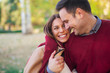 © Jelena - Close up of a smiling couple look at each other while walking in the park.