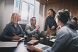 © Flamingo Images - Mature businessman talking with colleagues during a boardroom me