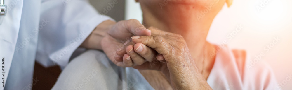 Geriatric doctor or geriatrician concept. Doctor physician hand on happy elderly senior patient to comfort in hospital examination room or hospice nursing home or wellbeing county. - obrazy, fototapety, plakaty 