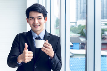 Portrait of young asian business  take action drinking a coffee cup to find idea for business finance concept