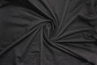 Wrinkled black fabric texture canvas image. Crumpled dark black fiber cloth, creasy cotton material background. Smooth plain black fabric rumpled surface
