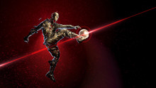 Bronze Soccer Player Holding A Jump Kick. Broken Into Small Fragments Against A Background Of Sparks And Flame With A Golden Ball. Concept Of Epic Victory In Sports 3d Render