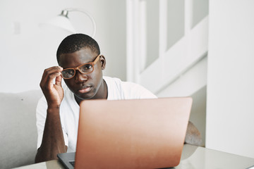 Wall Mural - A man of African appearance with a laptop