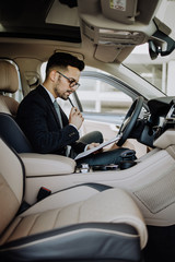 Poster - Car seller working in showroom and quality control checking of car details for the last time before buyer comes.