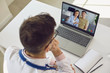 © Studio Romantic - Doctor medical online call.Shoulder view doctor therapist psychologist speaks with couple video chat using a laptop in a clinic office.