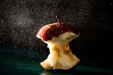 red apple rain drops dark background