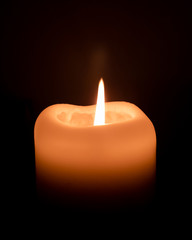 burning candle in the dark