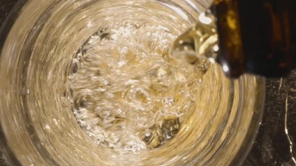 Sticker - Pouring beer into a glass. View from above. A jet of beer is poured into the glass, covering the bottom with foam and raising the level to the top of the glass.