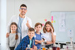 © Pixel-Shot - Teacher and pupils at chemistry lesson in classroom