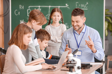 Poster - Teacher conducting physics lesson in classroom