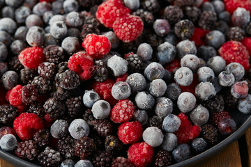 Wall Mural - frozen raspberries, blackberries and blueberries close up