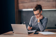 © kerkezz - Woman at home paying the bills online from her laptop