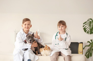 Poster - Little veterinarians examining animals in clinic