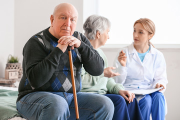 Wall Mural - Elderly people suffering from mental disability and doctor at home