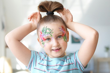 Poster - Funny little girl with face painting at home