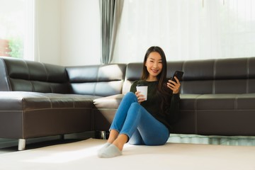 Canvas Print - Portrait beautiful young asian woman use smart mobile phone with coffee cup