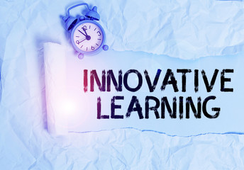Poster - Handwriting text writing Innovative Learning. Conceptual photo Interdisciplinary teaching that stirs analytic thinking Alarm clock and torn cardboard placed above plain pastel table backdrop