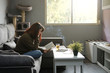 © Alejandro - Girl reading a book at home relaxing