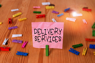 Conceptual hand writing showing Delivery Services. Concept meaning the transport of items between two or more parties Colored crumpled papers wooden floor background clothespin