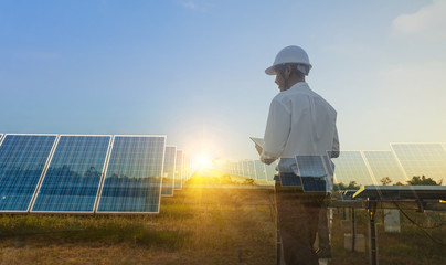 The solar farm(solar panel) with engineers walk to check the operation of the system, Alternative energy to conserve the world's energy, Photovoltaic module idea for clean energy production