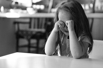 the child is bored, sad face. The girl is crying. The concept of childhood, children's day, kindergarten copyspace, bad mood, house arrest, disobedience, parenting, upset, emotions