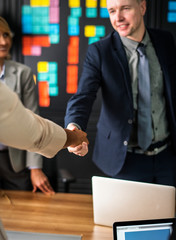 Wall Mural - Business people shaking hands in a meeting room