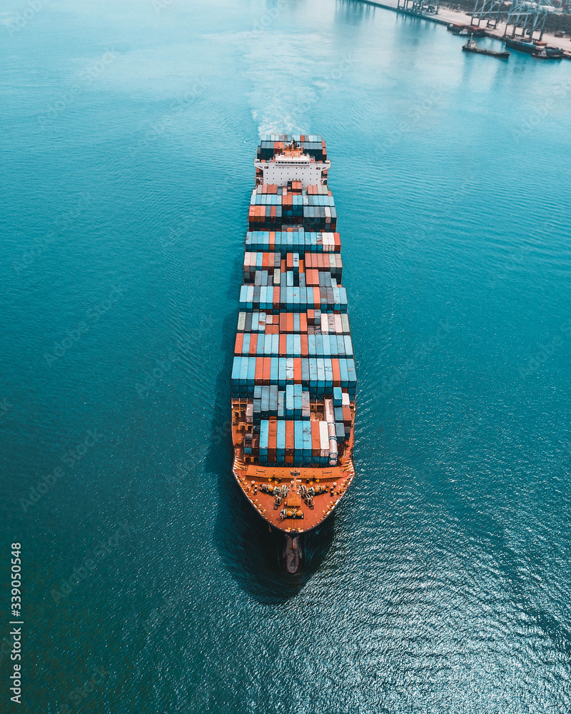 Container ship carries cargo, goods, and materials from one port to another for supplying purpose. - obrazy, fototapety, plakaty 