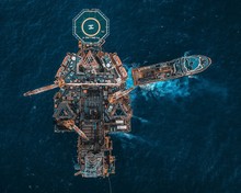 Aerial View Of Oil Rig Platform In The Middle Of Ocean.