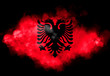 Albanian flag performed from color smoke on the black background. Abstract symbol.
