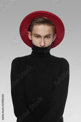 A Young Man With Light Brown Hair Is Wearing A Black Turtleneck And A Dark Red A Young Man With Light Brown Hair Is Wearing A Black Turtleneck And A Dark Red