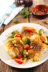 Wall Mural - baked fish fillet with broccoli and tomato