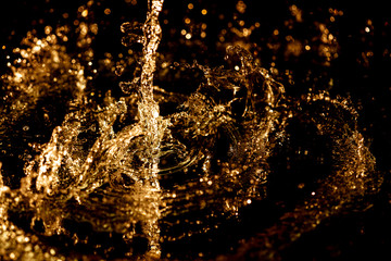 Wall Mural - Splashes and drops of water on a black background.