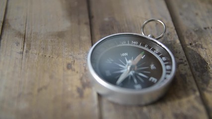 Wall Mural - Vintage compass close up on an old wooden barrel