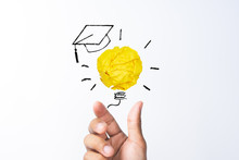 Education, Creative Idea, New Idea And Innovation Concept With Student Hand Holding Crumpled Yellow Paper Light Bulb With Graduation Hat Sketch Icon