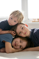 Wall Mural - Three beautiful children, boy brothers, having family portrait, hugging