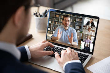Wall Mural - businessman boss leader leads distant communication diverse businesspeople involved in group videoca
