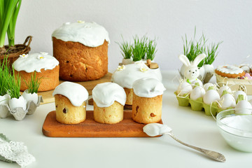 Easter sweet bread, Easter cake with green grass. Holidays breakfast concept with copy space. Easter greeting card template. Homemade pasques.Easter sweets on white background.