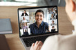 Laptop screen over woman shoulder view, indian businesswoman leading videoconference distant communication group videocall conversation. Diverse friends using modern tech enjoy virtual meeting concept