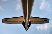 Tail Of An Aircraft With Elevator And A Brilliant Blue Sky Background. Lights Highlight The Tail