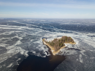 Wall Mural - Aerial view with an island on the Onega lake covered with ice, northwest of Russia