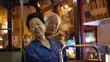 © glowonconcept - Asian elder couple have fun travel through Hong Kong city tram at night